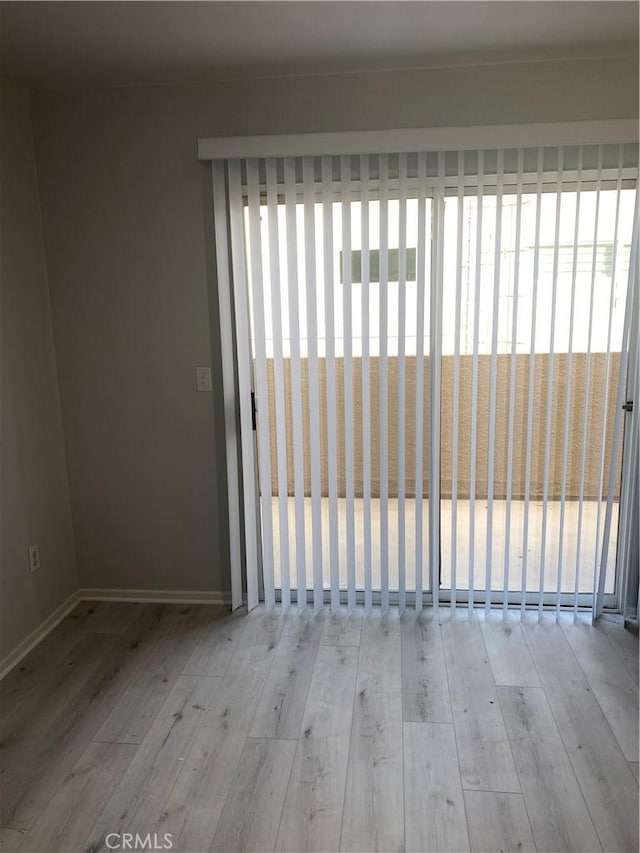 spare room with light hardwood / wood-style flooring and a healthy amount of sunlight