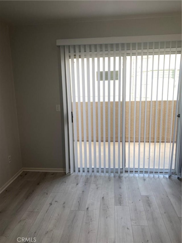 empty room with light hardwood / wood-style flooring