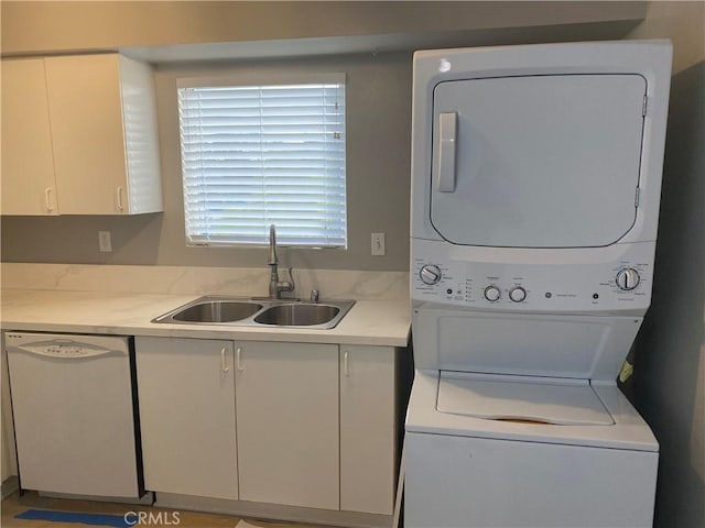 washroom featuring stacked washer / dryer and sink