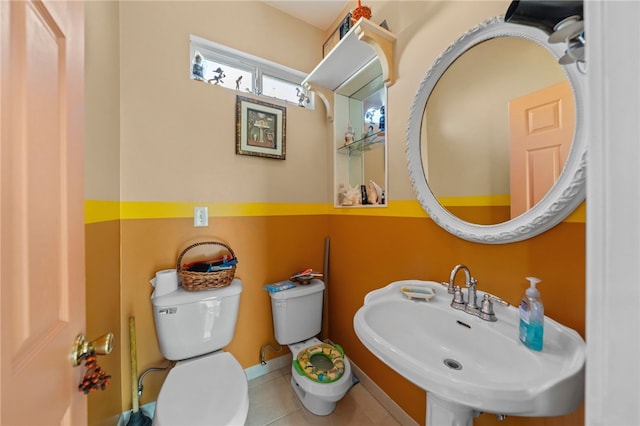 bathroom with tile patterned floors, toilet, and sink