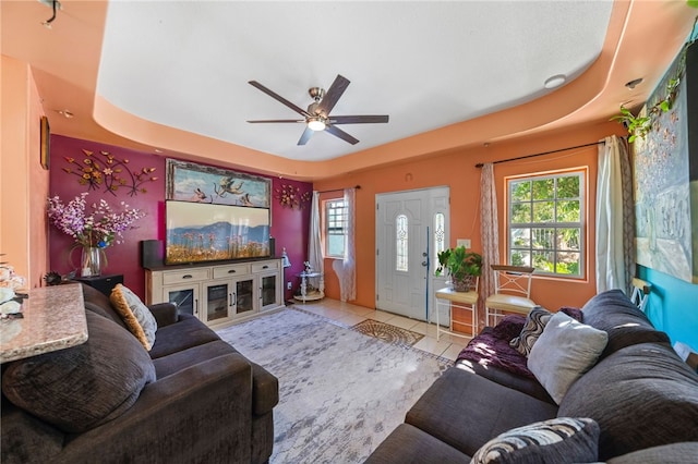 tiled living room with ceiling fan and a healthy amount of sunlight