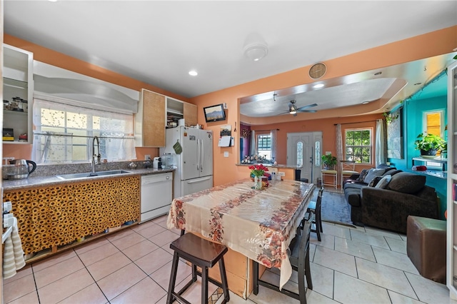 kitchen with ceiling fan, sink, light tile patterned floors, and white appliances