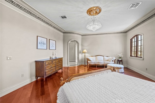 bedroom featuring ornamental molding, an inviting chandelier, and dark hardwood / wood-style flooring