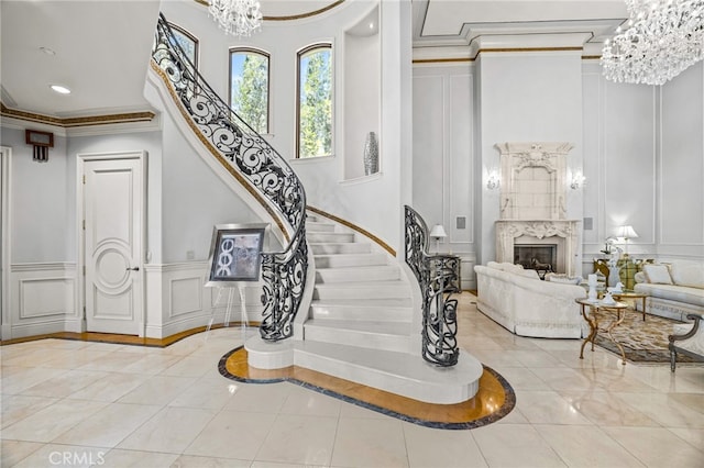 staircase with crown molding, tile patterned flooring, and a fireplace