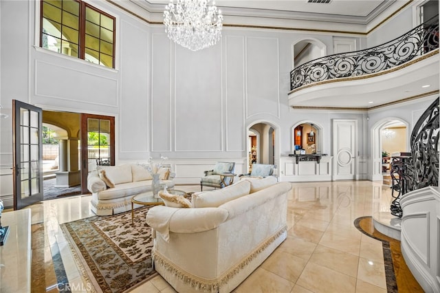 tiled living room with a notable chandelier, ornamental molding, and a high ceiling