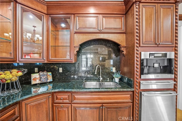 kitchen with tasteful backsplash, sink, dark stone counters, and stainless steel oven