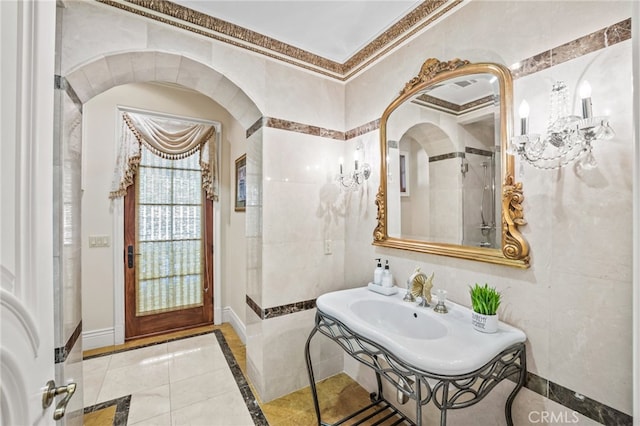 bathroom featuring crown molding, tile patterned floors, and tile walls