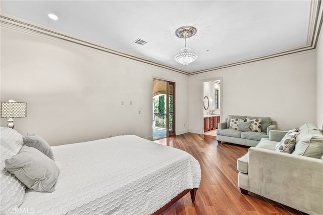 bedroom with connected bathroom, access to outside, ornamental molding, hardwood / wood-style floors, and an inviting chandelier