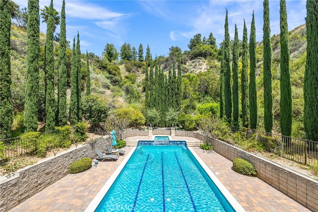 view of swimming pool with a patio area