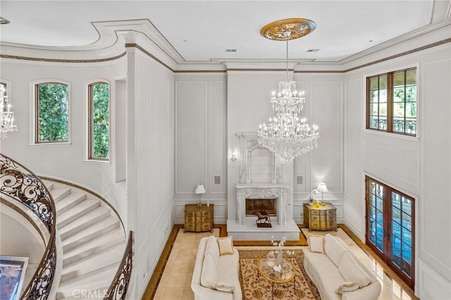 living room with crown molding, plenty of natural light, and a fireplace