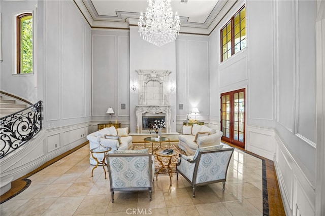 living room with crown molding, a fireplace, and a wealth of natural light