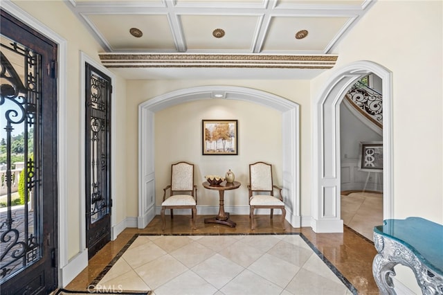 interior space featuring light tile patterned flooring, beamed ceiling, and coffered ceiling