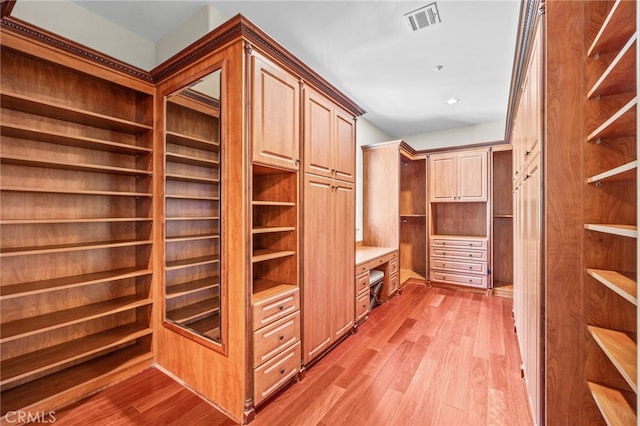 wine cellar with light hardwood / wood-style flooring