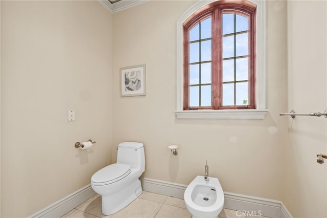 bathroom featuring toilet, crown molding, a bidet, and tile patterned flooring