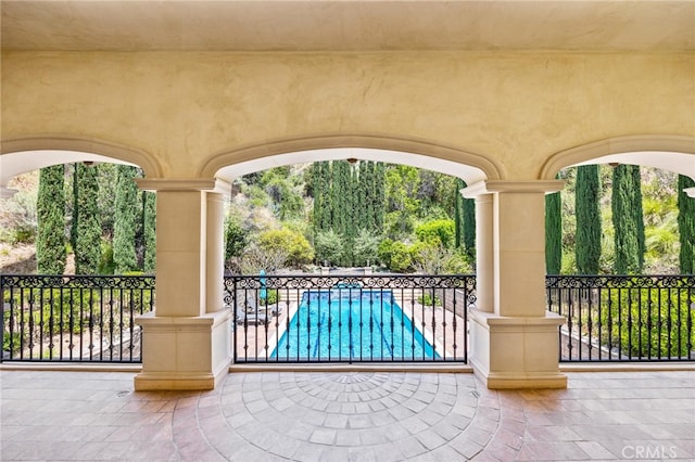 view of gate with a fenced in pool