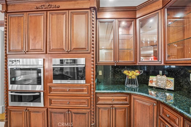 kitchen featuring dark stone counters and backsplash