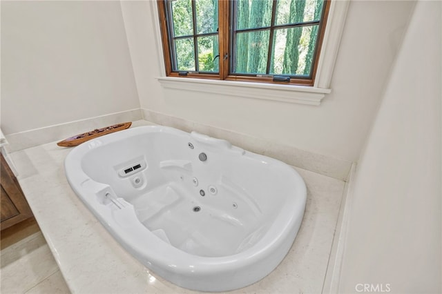 bathroom with a tub and tile patterned flooring