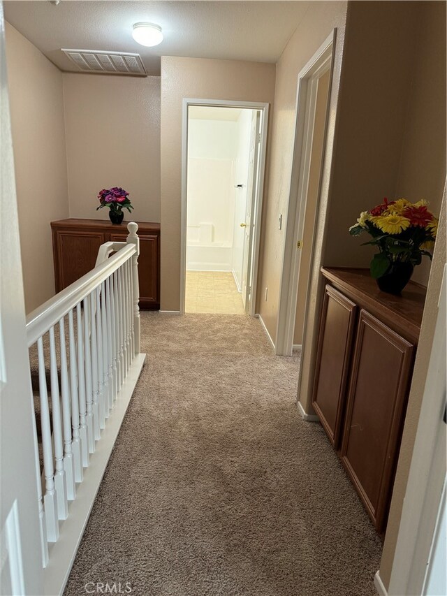 corridor with light colored carpet