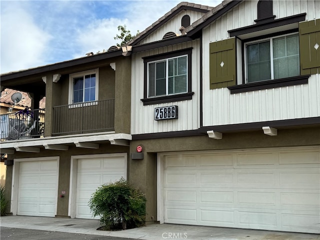 view of property featuring a balcony and a garage