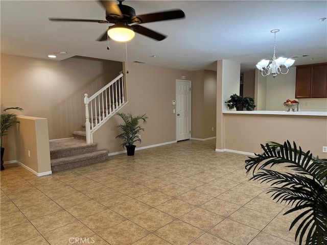 interior space featuring ceiling fan with notable chandelier