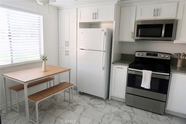 kitchen featuring appliances with stainless steel finishes and white cabinetry