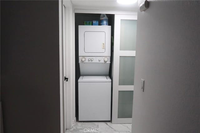 laundry area featuring stacked washer / dryer