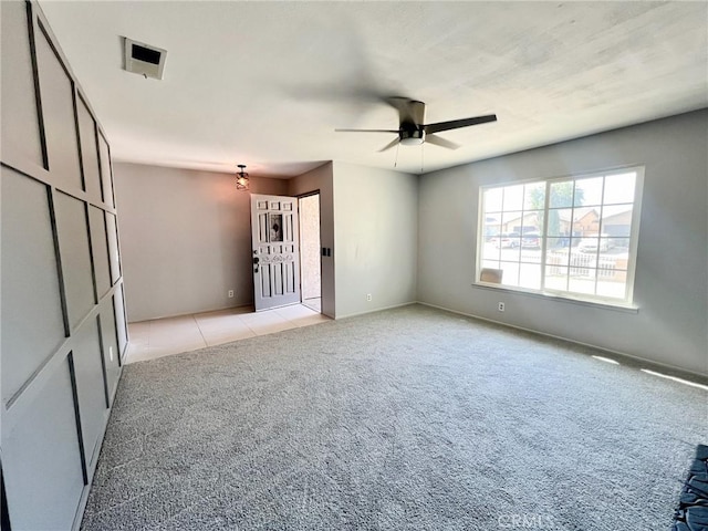 unfurnished room with light carpet and ceiling fan