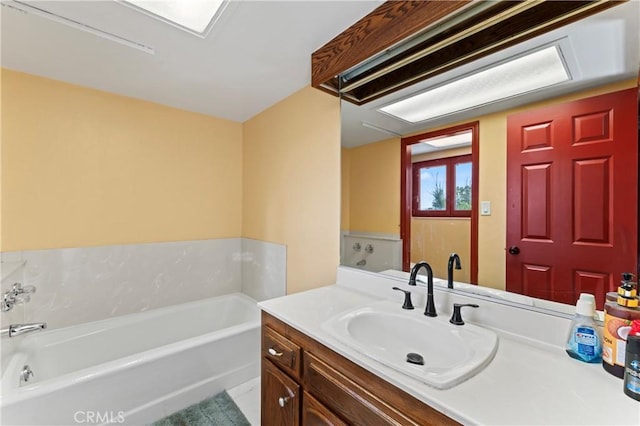 bathroom with vanity and a bathtub