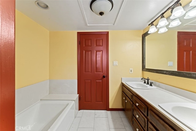 bathroom featuring tile patterned floors, vanity, and a bath