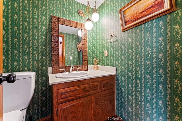 bathroom featuring vanity and toilet