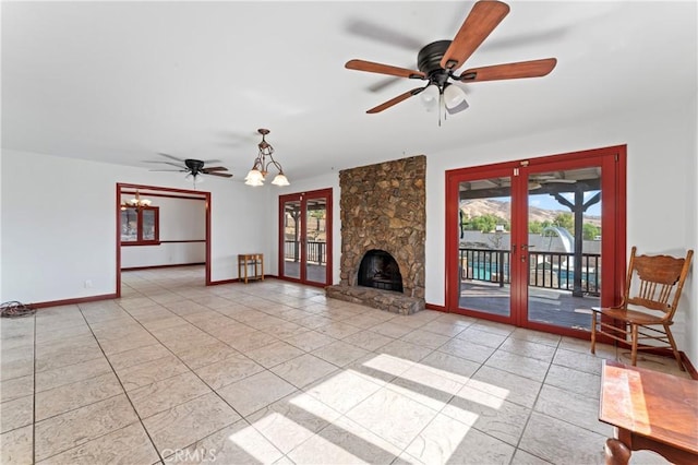 unfurnished living room featuring french doors, ceiling fan with notable chandelier, and light tile patterned flooring