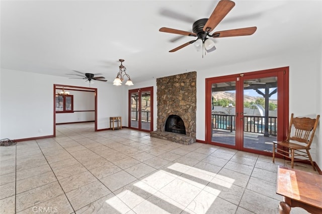 unfurnished living room featuring french doors, ceiling fan with notable chandelier, and light tile patterned floors