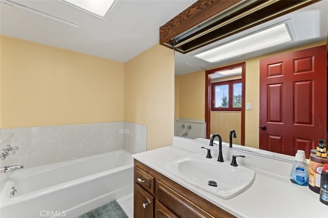 bathroom with vanity and a bath