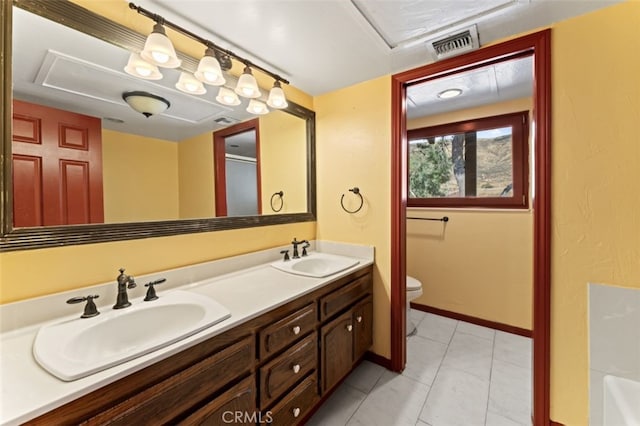 bathroom featuring tile patterned flooring, vanity, and toilet