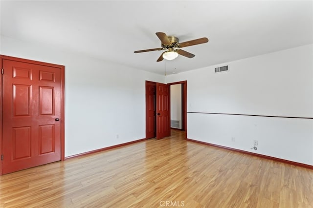 spare room featuring ceiling fan and light hardwood / wood-style floors