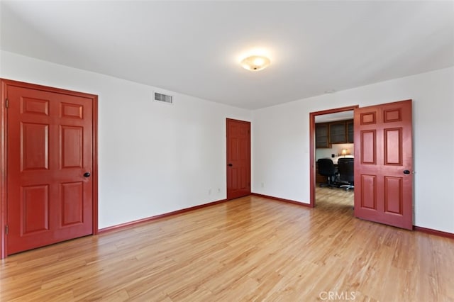 spare room featuring light hardwood / wood-style floors