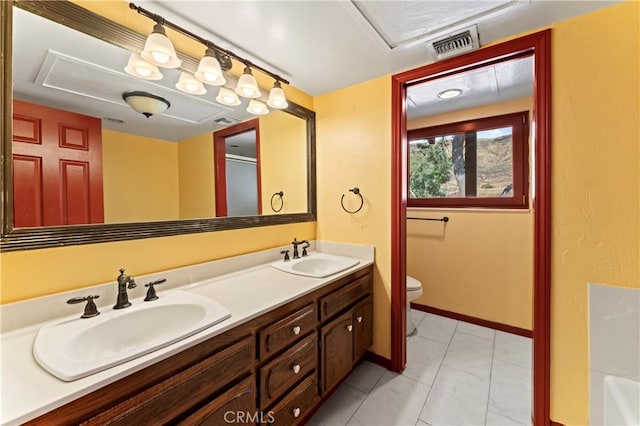 bathroom with tile patterned floors, vanity, and toilet