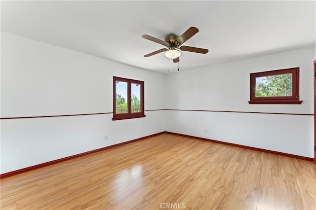 unfurnished room with ceiling fan and light hardwood / wood-style flooring