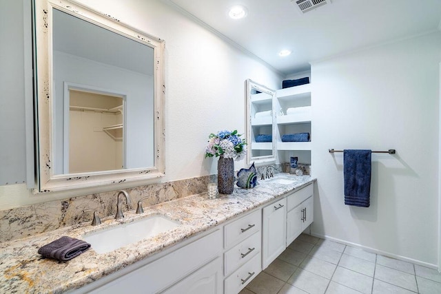 bathroom with tile patterned flooring, vanity, and ornamental molding