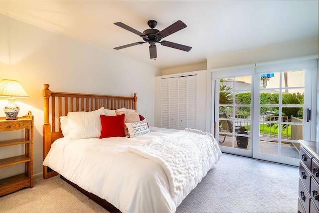 bedroom with access to exterior, ceiling fan, a closet, and light carpet