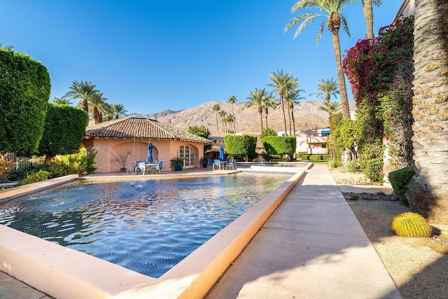 view of swimming pool with a mountain view