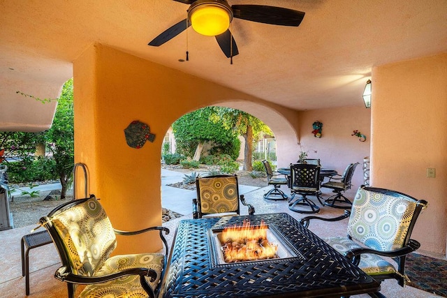 view of patio / terrace featuring ceiling fan and an outdoor fire pit