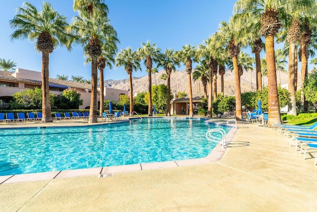 view of swimming pool featuring a mountain view and a patio