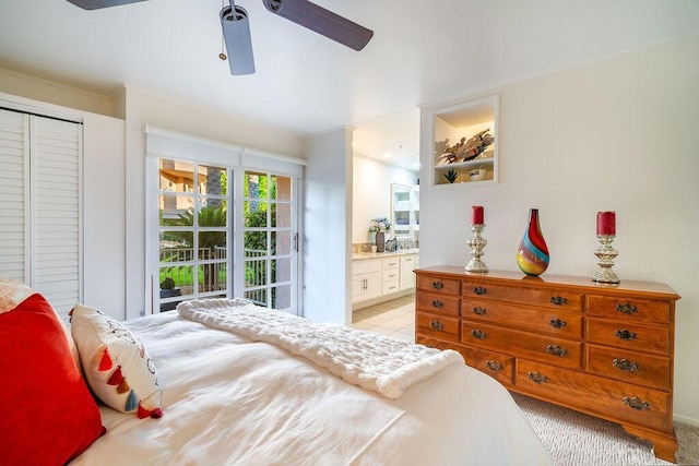 bedroom featuring ceiling fan, a closet, crown molding, and ensuite bath