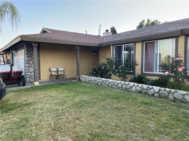 view of front of property with a front yard and a garage