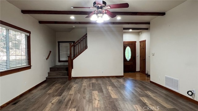 interior space featuring beamed ceiling, dark wood-type flooring, and ceiling fan