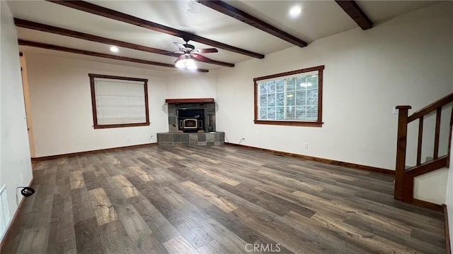 24861 Finhaut Dr, Crestline, CA 92325 - unfurnished living room featuring ceiling fan, beam ceiling, wood finished floors, stairway, and a fireplace