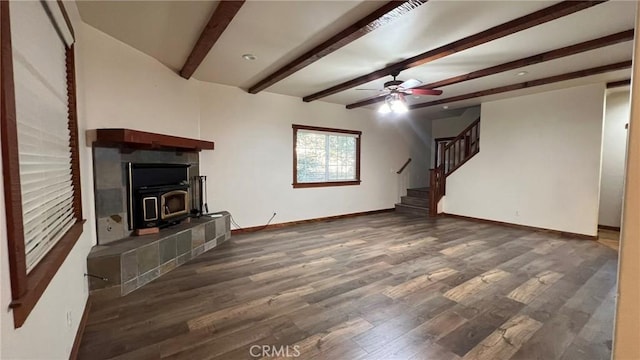 24861 Finhaut Dr, Crestline, CA 92325 - unfurnished living room with a wood stove, stairway, ceiling fan, beam ceiling, and wood finished floors