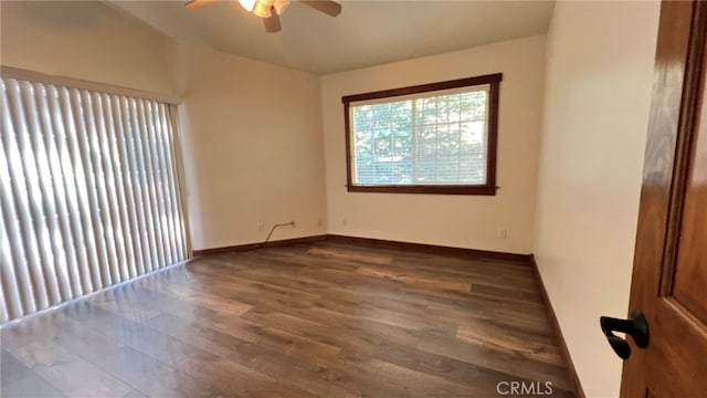 spare room with dark wood-type flooring and ceiling fan