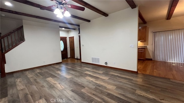 unfurnished living room featuring beam ceiling, ceiling fan, and dark hardwood / wood-style flooring